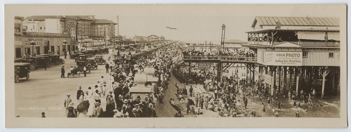People walking along the seawall and beach in Galveston, Texas on the Gulf Coast