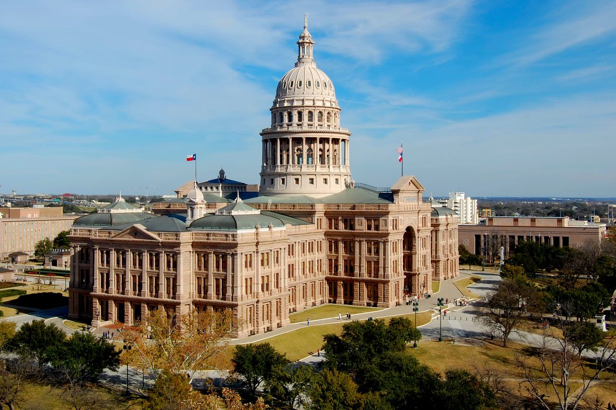 The Texas State Capitol building in Austin under a clear blue sky